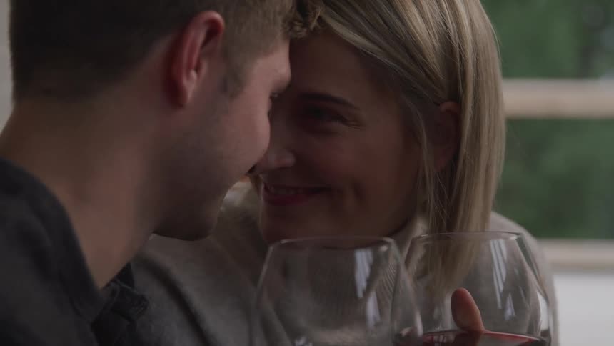 Blonde woman and white man look at each others eyes with affection and love