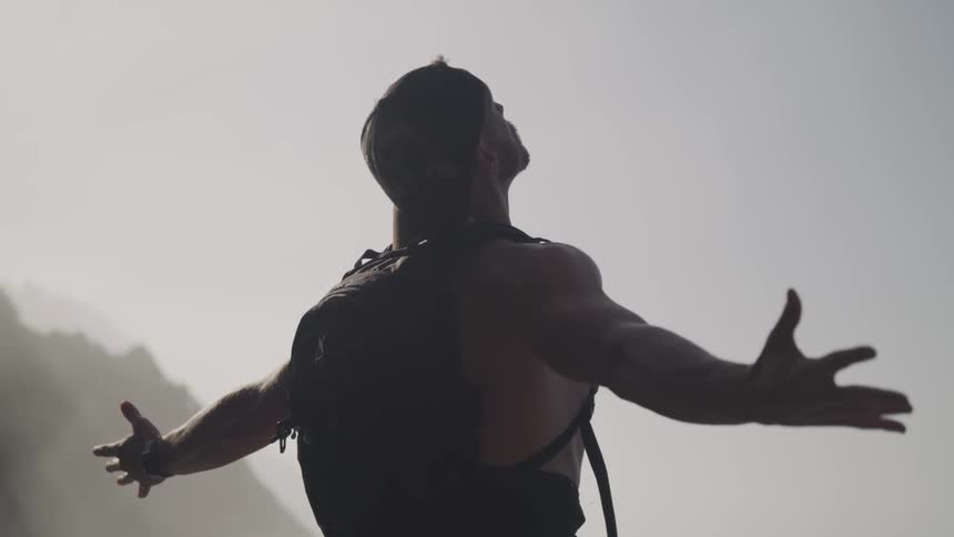 A man is hiking outdoors by a mountain