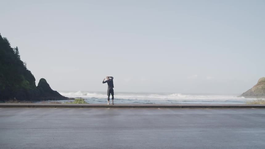 A man standing on the shore stretching