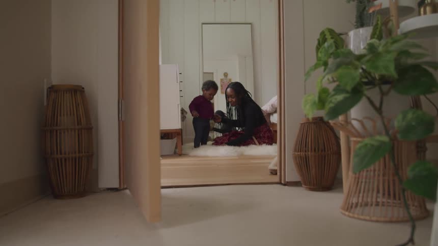 A black mother and son in a room together
