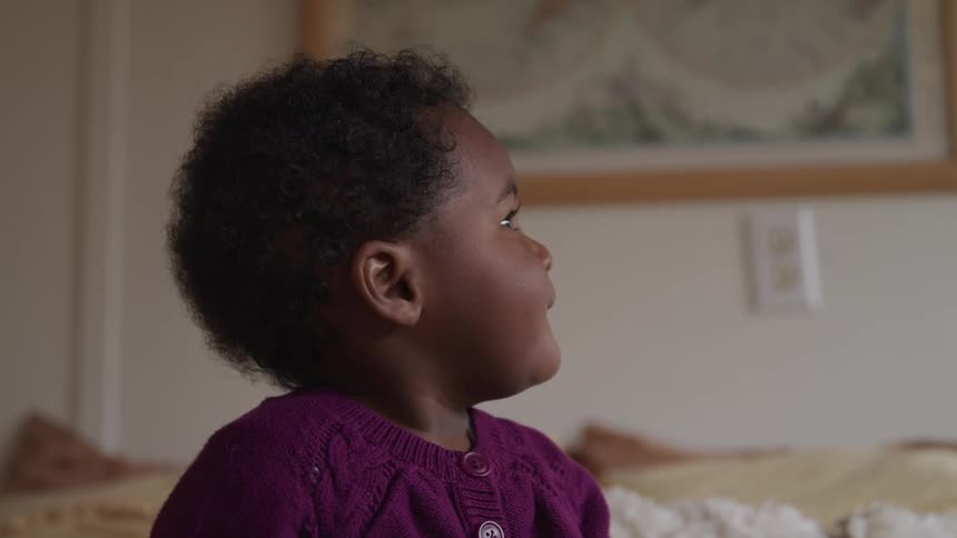 A baby girl looking around her home