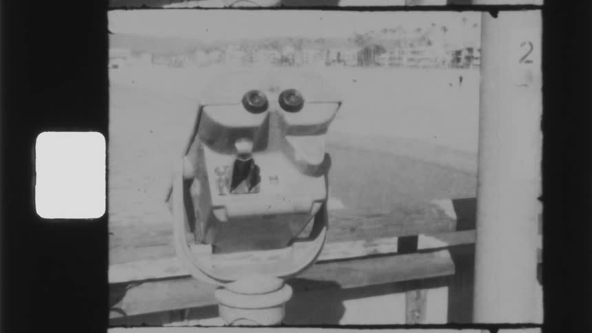 A viewfinder on the boardwalk of a beach on a sunny day
