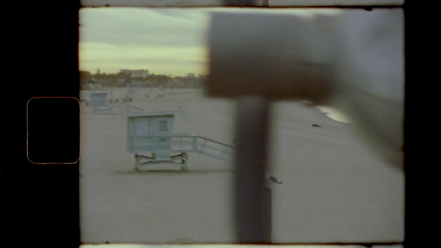 A lifeguard tower overlooking a beach in the evening