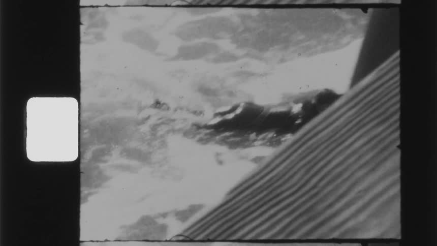 Black and white footage of a man swimming