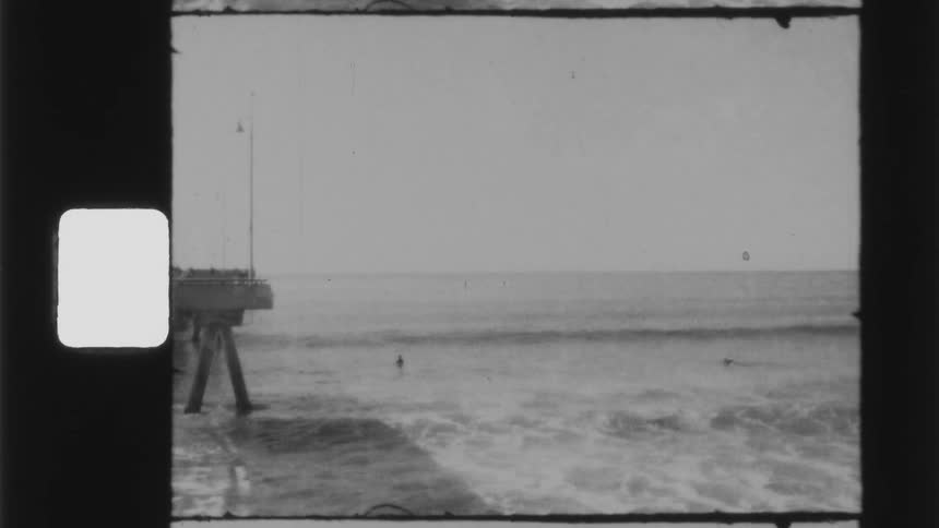 The waves hit the shore by the pier