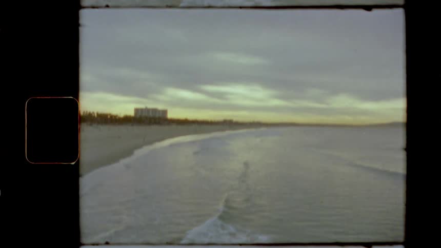 Film footage of waves rolling in to the beach