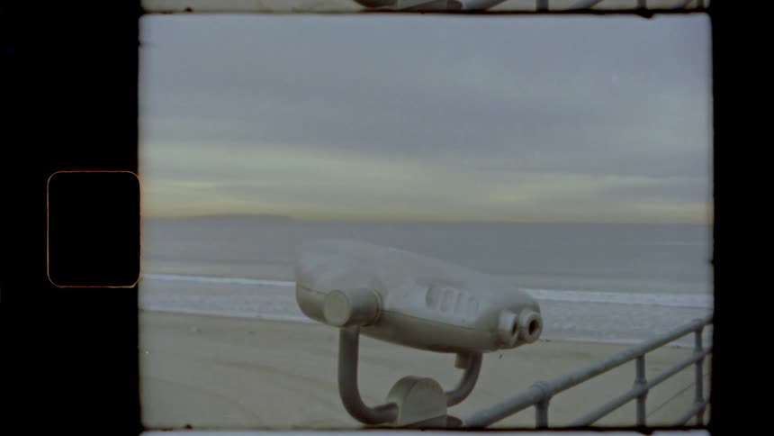 Vintage footage of a telescope at a beach