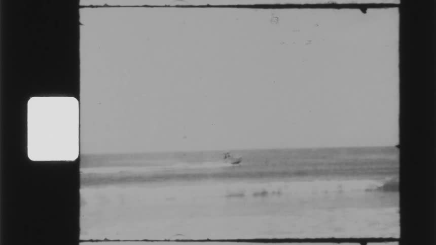 Footage of a ship moving in the ocean is displayed