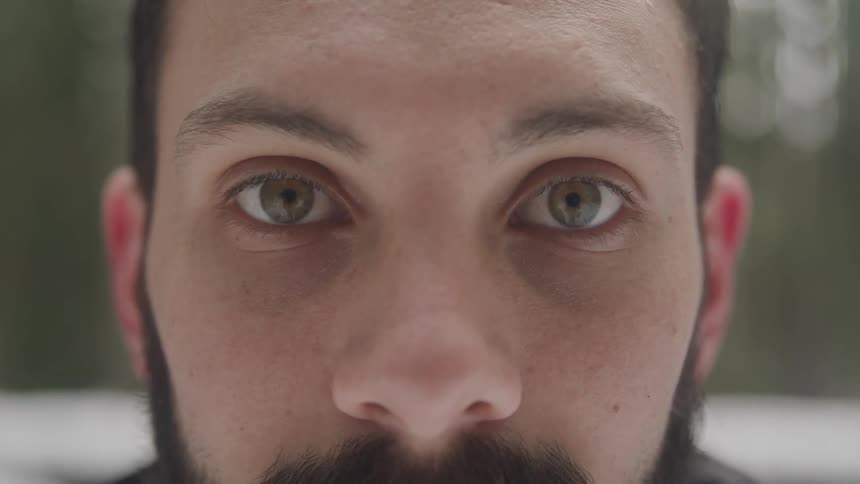 A male standing and staring ahead