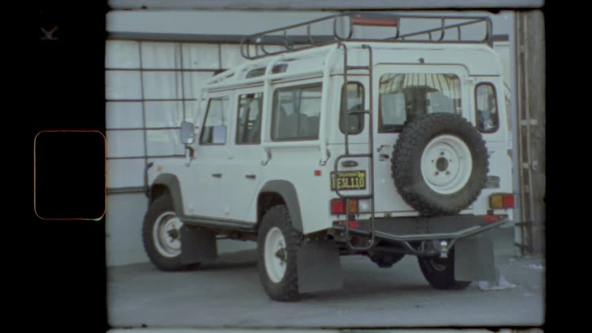 White all terrain vehicle parked on the street in front of a closed store