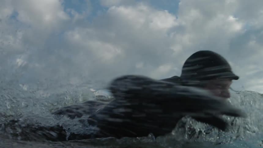 A person paddling on a surfboard