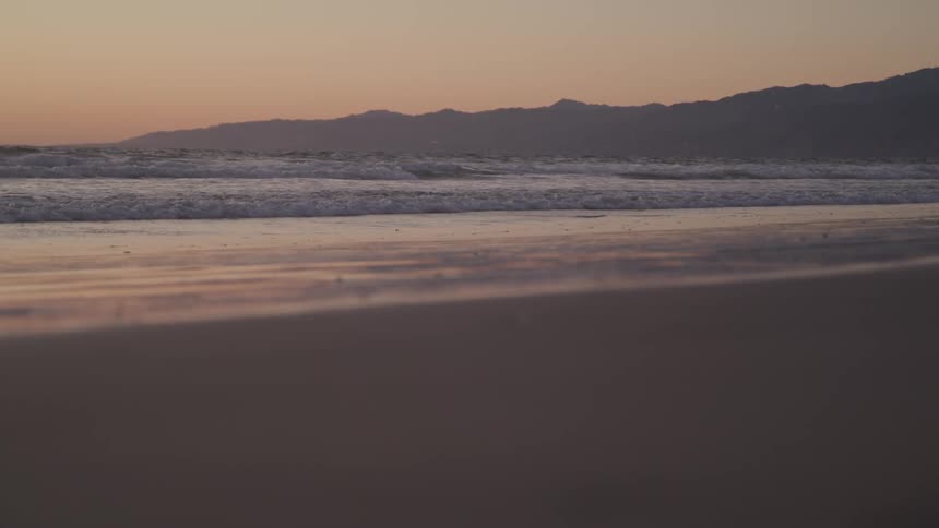 The sun sets over a calm ocean