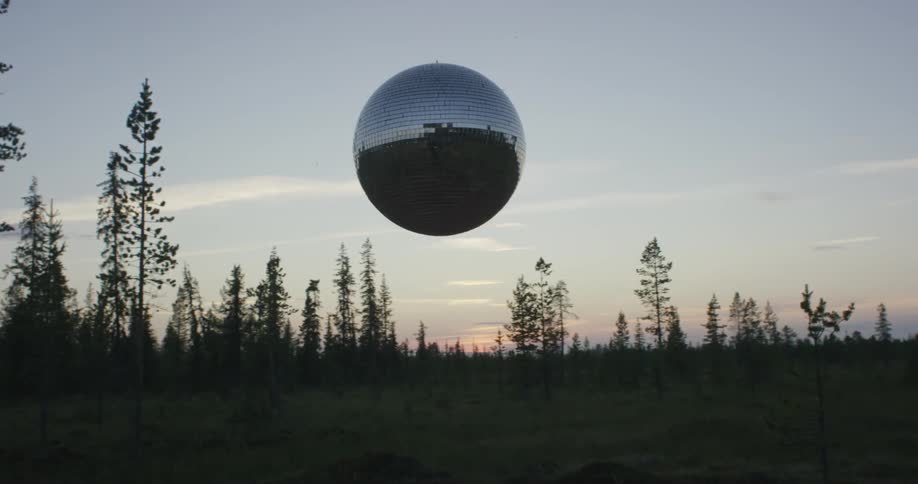 A silver glove is floating at sunset