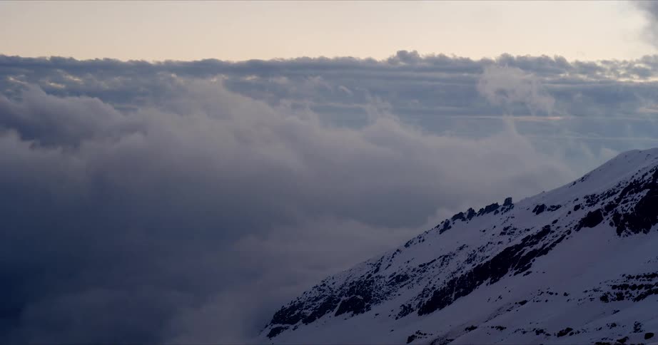 Timelapse of clouds in mountains at sunset