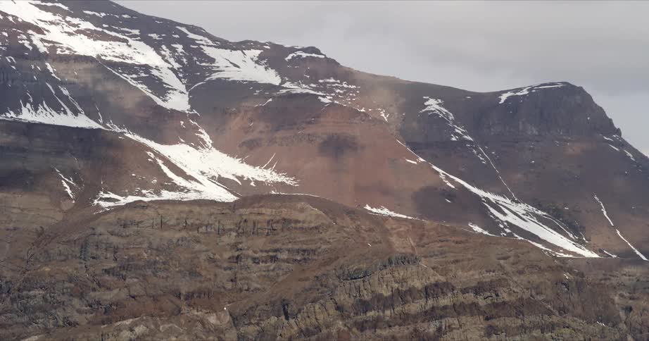 Clouds slowly move across the face of Andes mountains