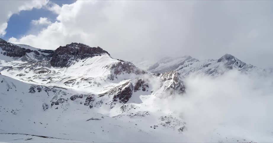Clouds roll over a winter mountainscape