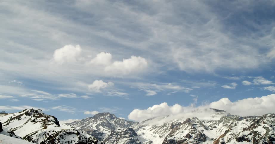 Timelapse of roiling clouds over winter mountains