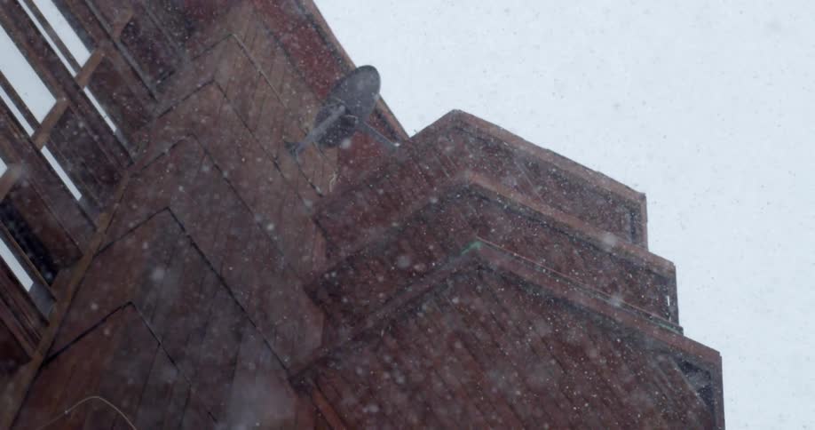 Snow falling on a building
