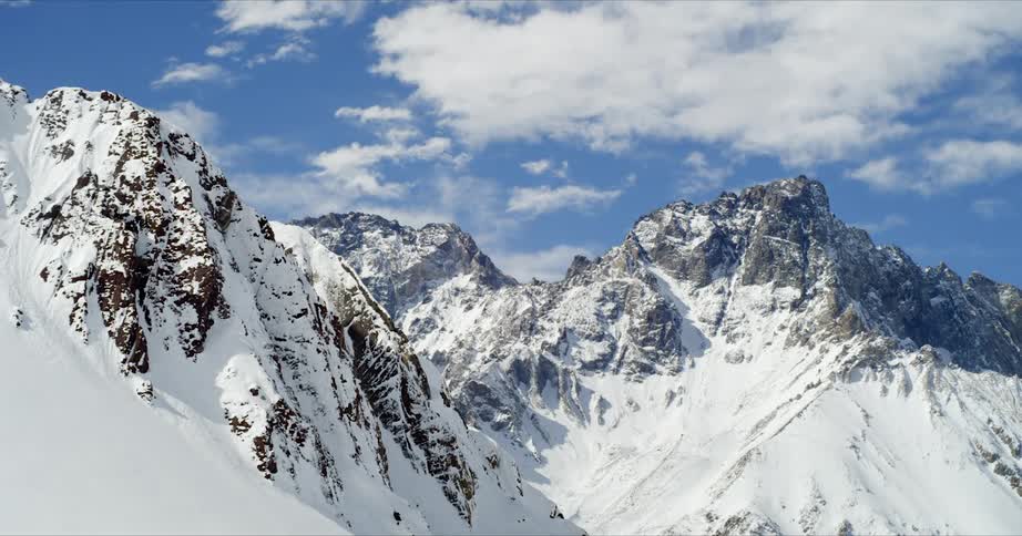 Timelapse of clouds over rugged winter peaks