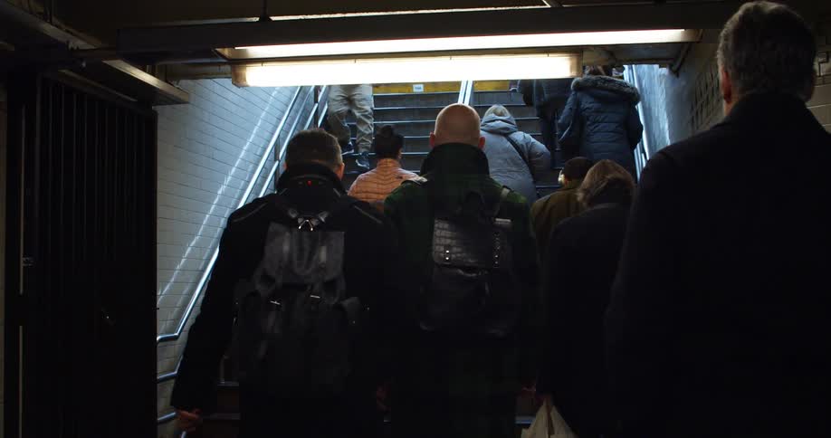 A group of people walking on stairs in a building