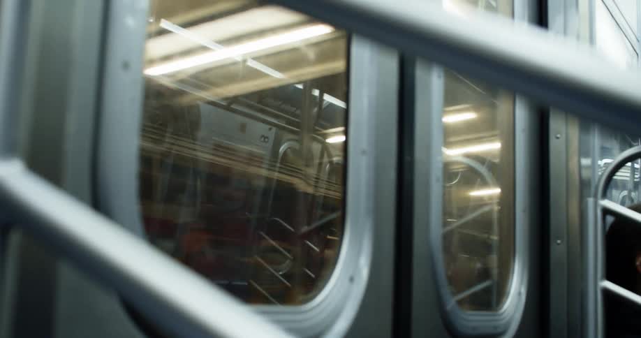 The door of a subway train as it travels through a station