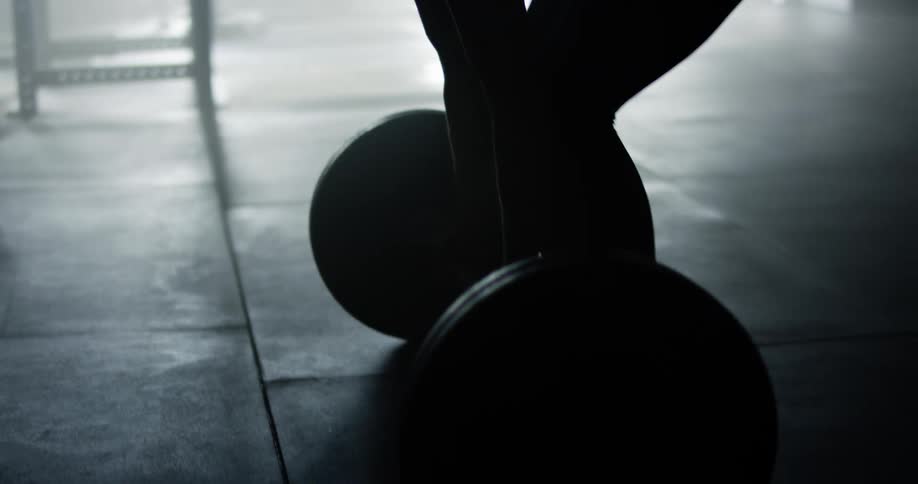 A female inside a gym lifting weights
