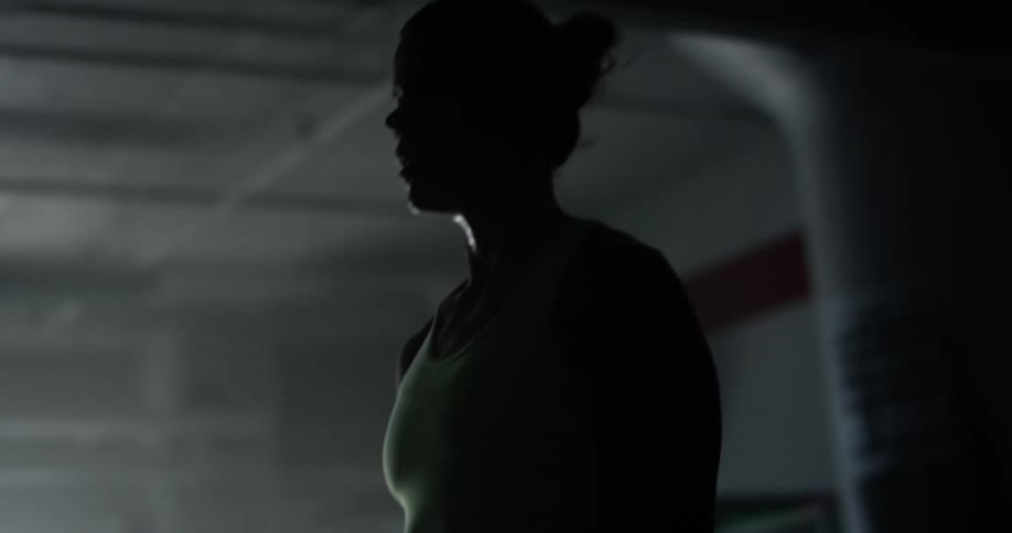 A woman is lifting weights in a gym