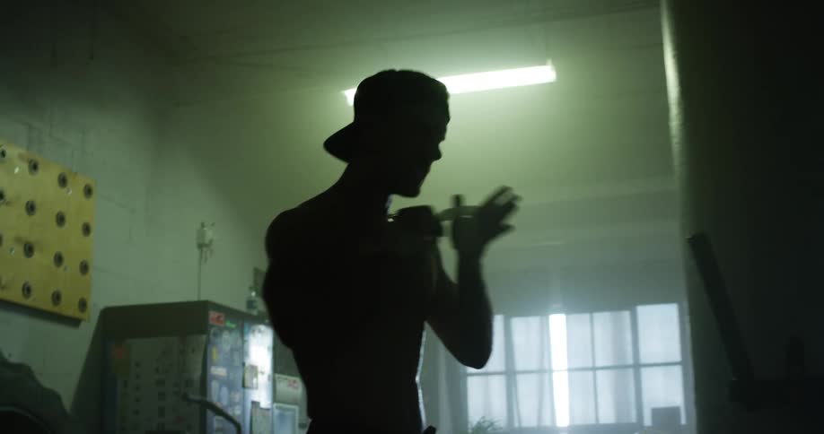 A male caucasian taping his hands in a gym