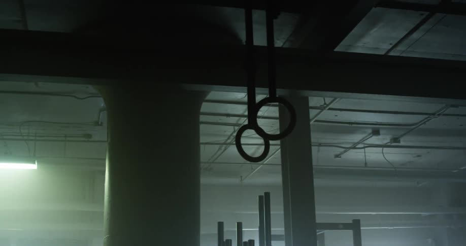 The inside of a gym with exercise equipment including gymnastic hoops