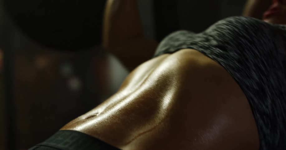 A female caucasian lifting weights in a gym