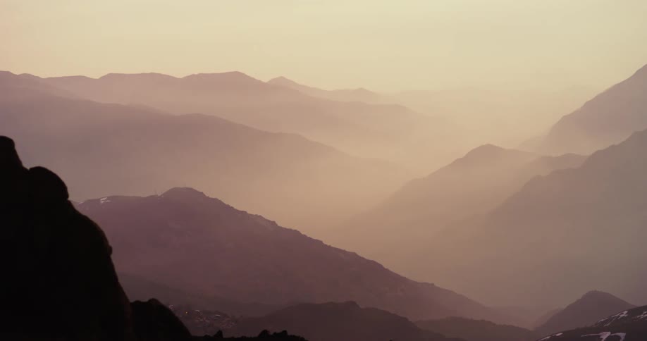 Layers of mountains in sunset mist