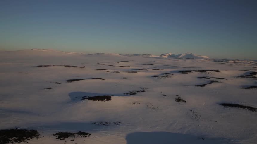 A snowy and slightly hilly landscape