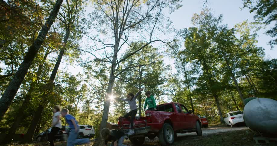 Kids jump from back of pickup truck and run together