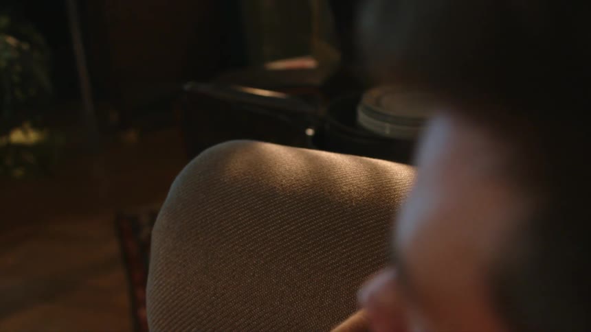A man is sitting using a remote