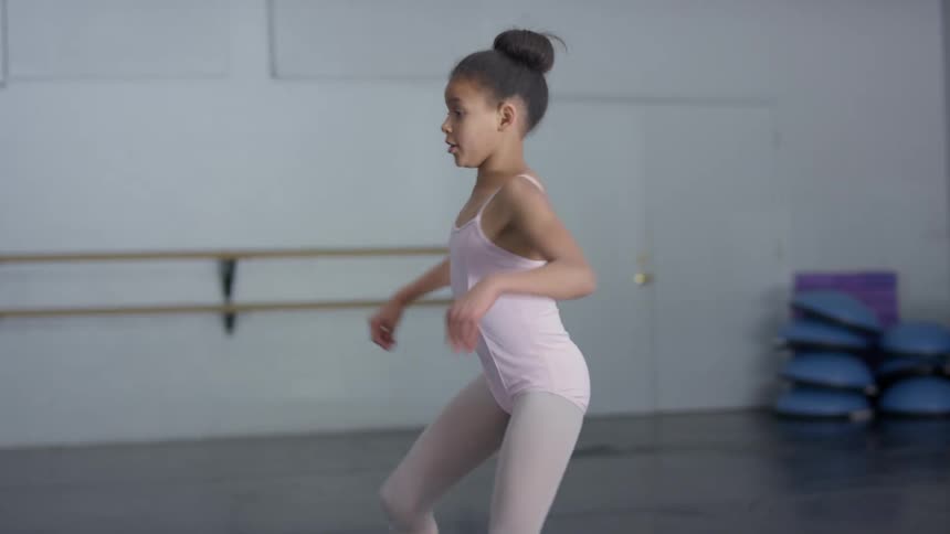 Young girl practices ballet twirls