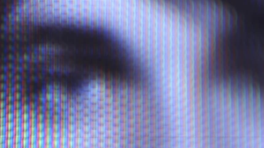 Persons eyes staring at camera from screen
