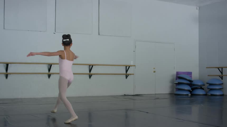 A little girl practicing ballet
