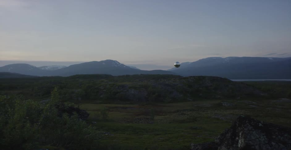 A silver orb flying above a natural area