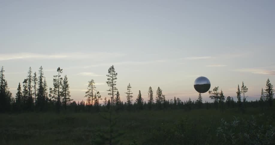 A silver ball hovers over a field