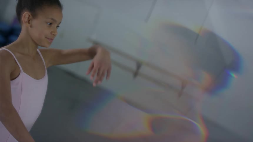 A child black ballerina dancing and posing in a dance studio