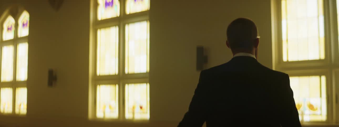 A man is walking through a building in a city