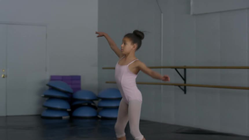 A young girl practicing ballet