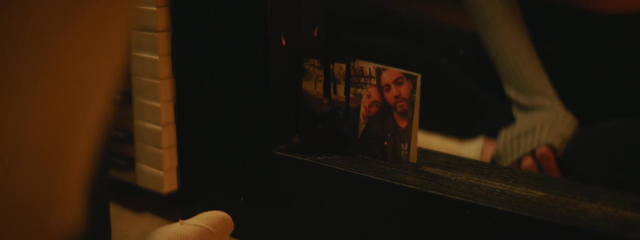 A person is sitting in front of the mirror