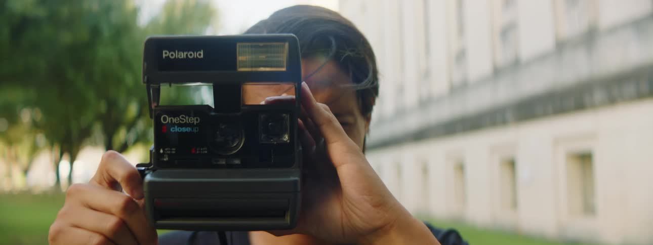 A man is taking photos outdoors