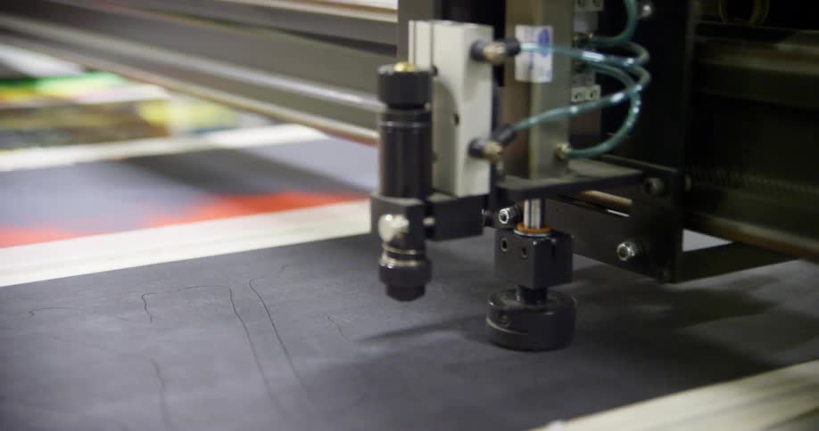 A machine printing on a piece of material
