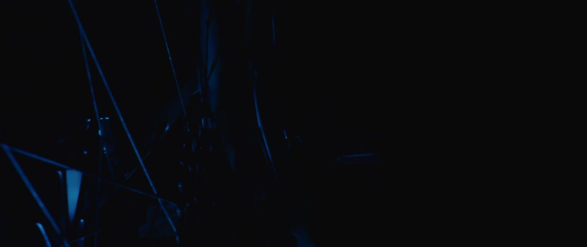 A bike is parked in the dark