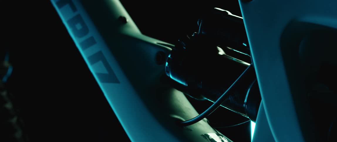 Close up of the frame of a sports bicycle in a dark room