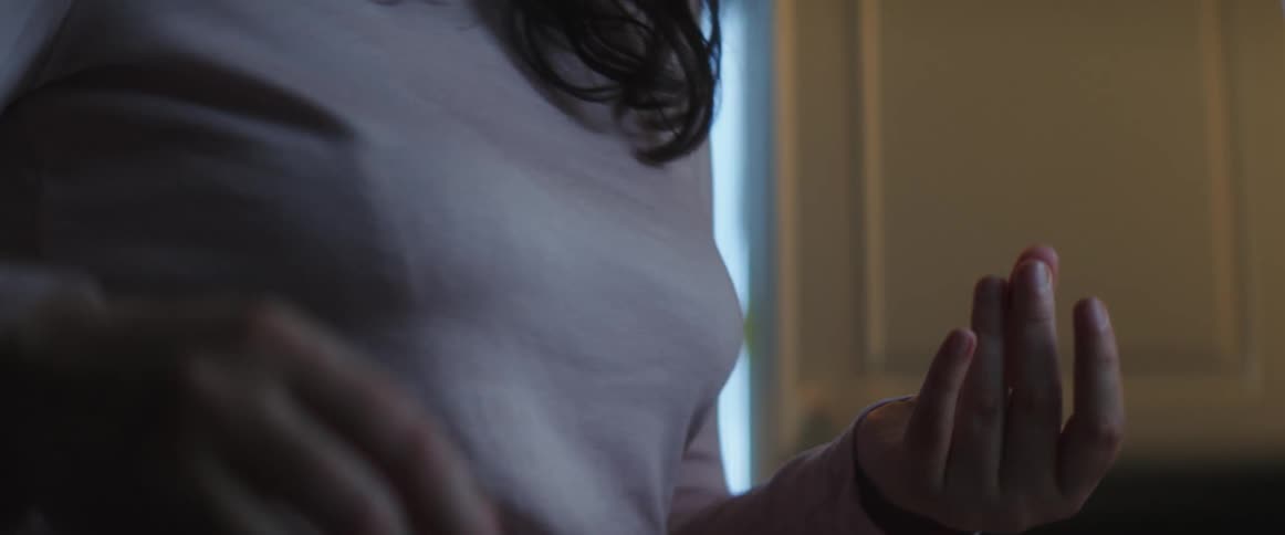 A male hugging a woman and she shoves him away