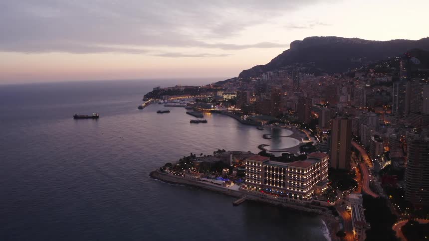 The city buildings are lit by the shore