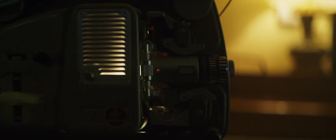 A projector is running in the dark room